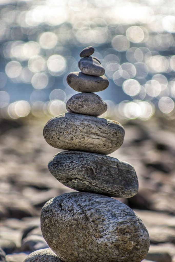 Balanced stones representing retirement wellness coaching and a steady transition into retirement